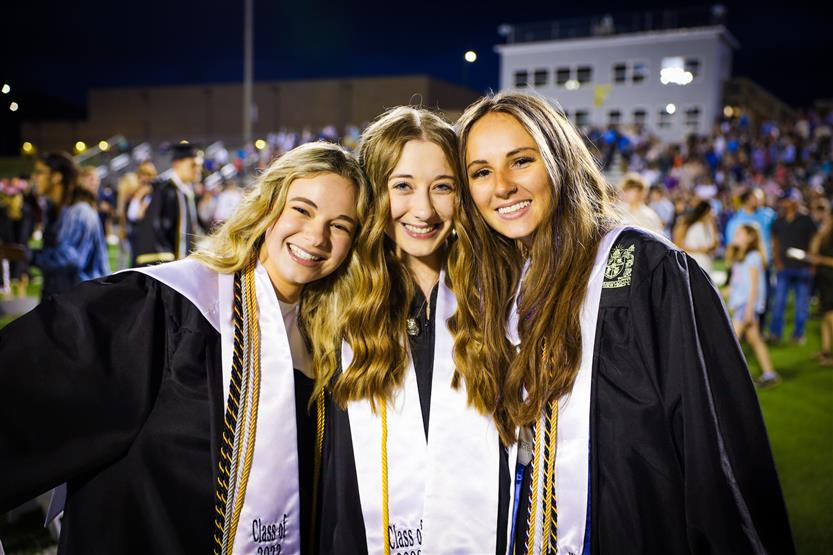 Students graduate on a football field